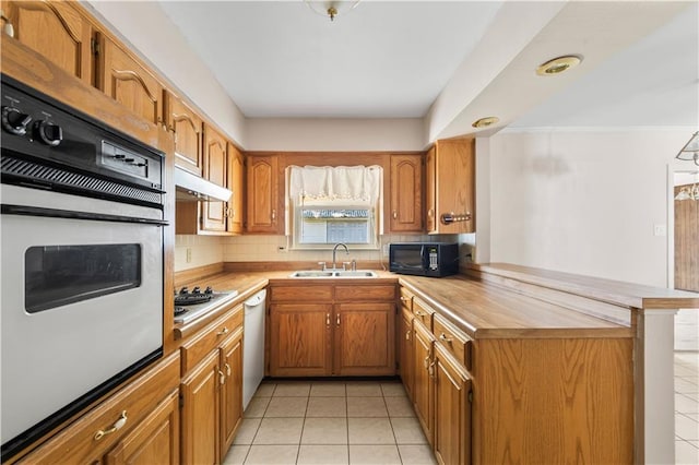 5504 Sabine Dr, Marrero, LA 70072 - kitchen featuring a sink, white appliances, a peninsula, light tile patterned floors, and under cabinet range hood