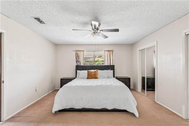 5504 Sabine Dr, Marrero, LA 70072 - bedroom featuring light carpet, baseboards, ceiling fan, a closet, and a textured ceiling