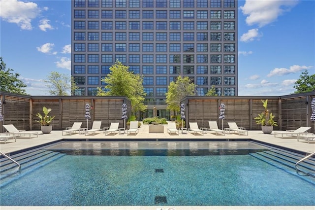 community pool featuring a patio and fence