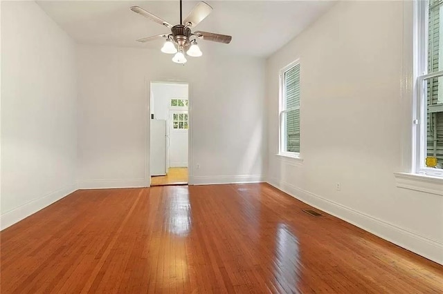 8-10 Neron Pl, New Orleans, LA 70118 - spare room with plenty of natural light, wood finished floors, and a ceiling fan