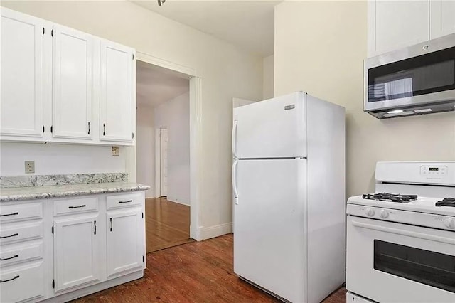 8-10 Neron Pl, New Orleans, LA 70118 - kitchen with white appliances, dark wood-type flooring, white cabinetry, and light stone countertops