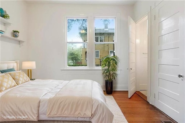 8-10 Neron Pl, New Orleans, LA 70118 - bedroom featuring wood finished floors and baseboards
