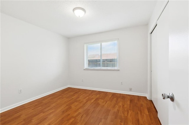 2701 Chenier St, Marrero, LA 70072 - unfurnished bedroom with wood finished floors, baseboards, and a closet