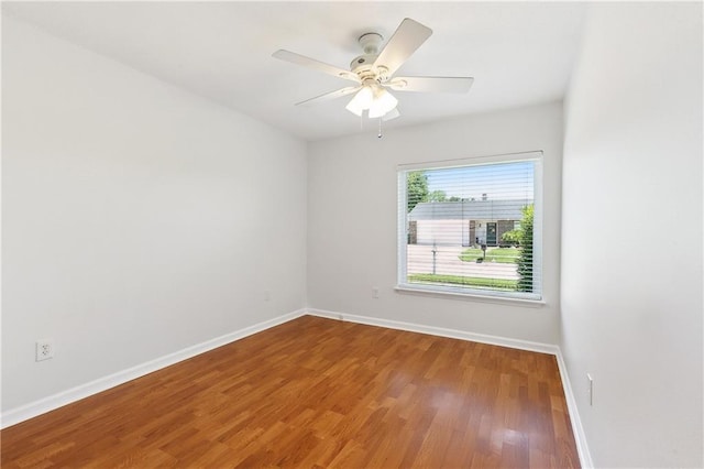 2701 Chenier St, Marrero, LA 70072 - empty room featuring baseboards, wood finished floors, and a ceiling fan