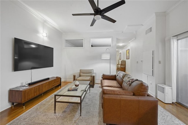 760 Magazine St Unit 113, New Orleans, LA 70130 - living room featuring wood finished floors, crown molding, a ceiling fan, and baseboards