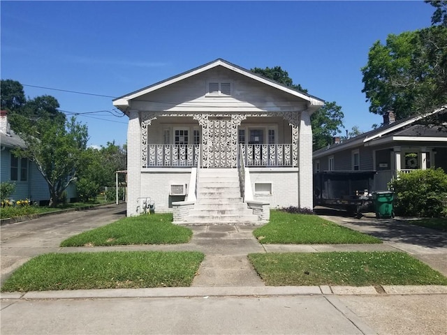 11921 Hesper Ave, Metairie, LA 70005 - view of front of property featuring brick siding, covered porch, and stairway