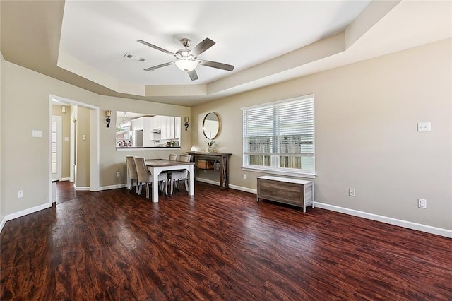 5926 Tullis Dr, New Orleans, LA 70131 - dining space with a raised ceiling, a ceiling fan, and wood finished floors