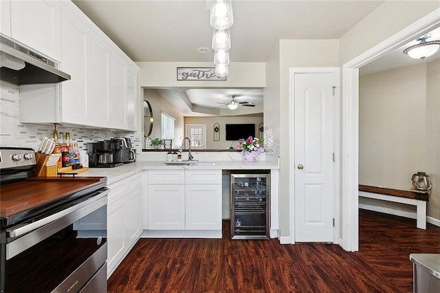 5926 Tullis Dr, New Orleans, LA 70131 - kitchen with stainless steel electric range oven, wine cooler, a sink, under cabinet range hood, and a ceiling fan