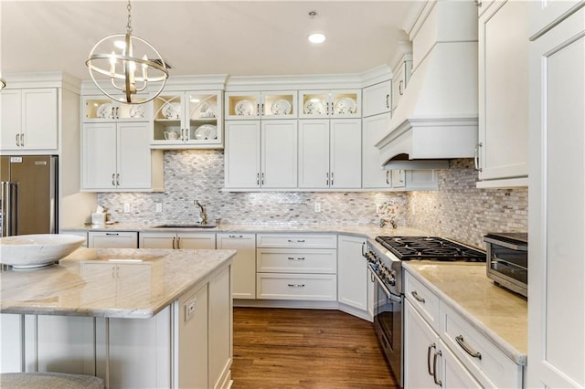 232 Lake Marina Ave Unit 10-D, New Orleans, LA 70124 - kitchen featuring appliances with stainless steel finishes, custom exhaust hood, a sink, a chandelier, and decorative light fixtures