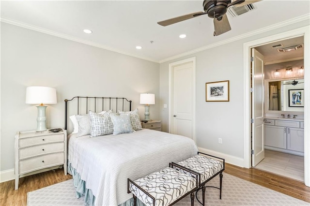 232 Lake Marina Ave Unit 10-D, New Orleans, LA 70124 - bedroom with wood finished floors, baseboards, a sink, recessed lighting, and ensuite bathroom