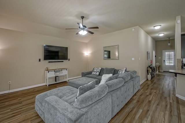 living room with ceiling fan, wood finished floors, and baseboards