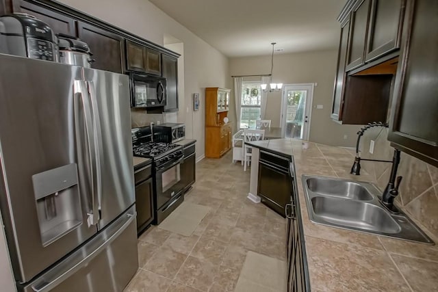 kitchen with black appliances, a sink, dark brown cabinets, tile counters, and pendant lighting