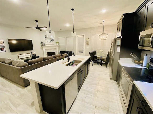 1758 Mary Dr, Slidell, LA 70458 - kitchen featuring stainless steel appliances, a sink, dark cabinets, light countertops, and ceiling fan
