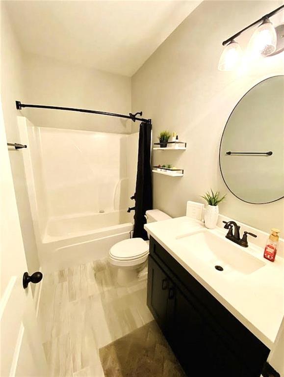 1758 Mary Dr, Slidell, LA 70458 - full bath featuring toilet, vanity, and shower / tub combo with curtain
