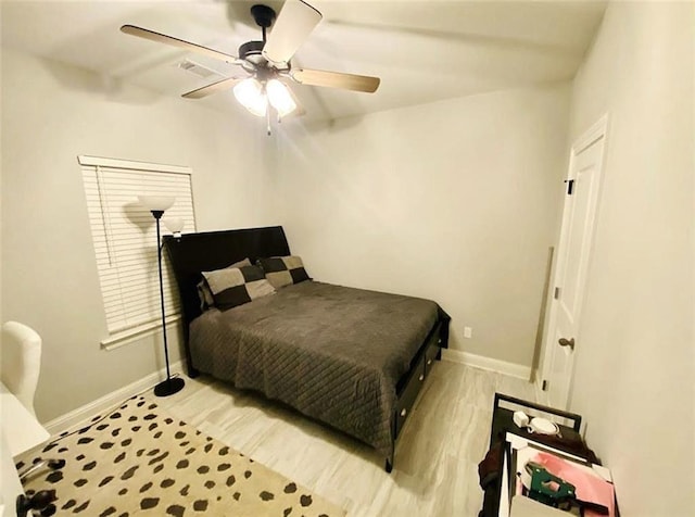 1758 Mary Dr, Slidell, LA 70458 - bedroom with baseboards, light wood finished floors, and a ceiling fan