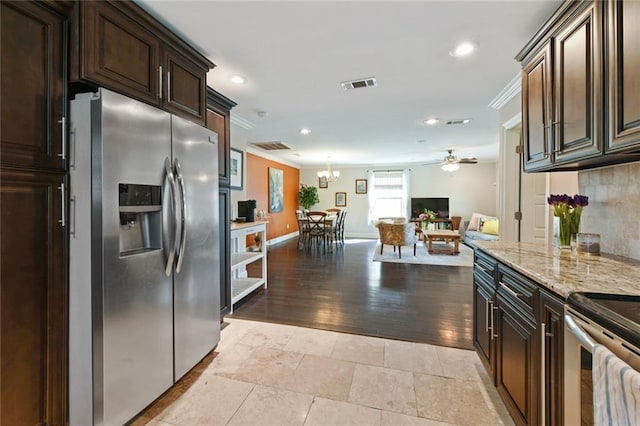 5517 N Rampart St, New Orleans, LA 70117 - kitchen featuring appliances with stainless steel finishes, crown molding, a ceiling fan, baseboards, and light stone counters
