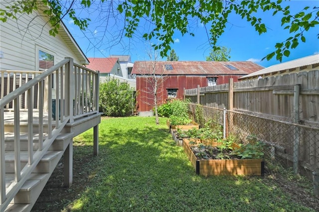 5517 N Rampart St, New Orleans, LA 70117 - view of yard featuring a vegetable garden, an outdoor structure, and a wooden deck