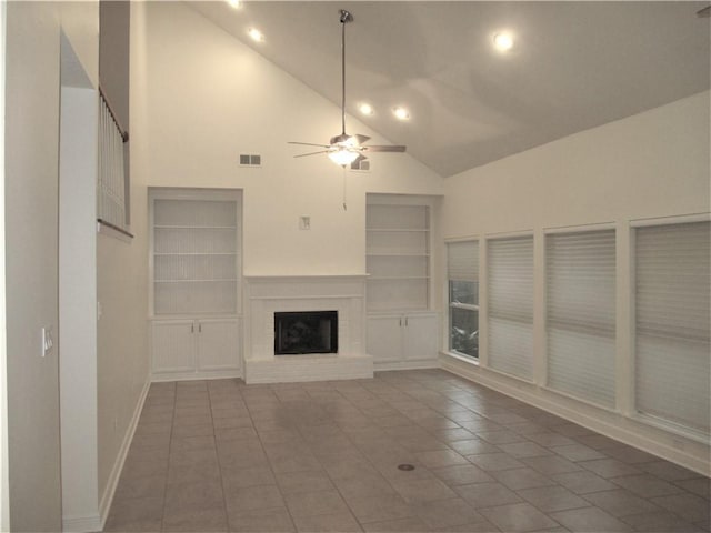57 Elizabeth Ct, Mandeville, LA 70448 - unfurnished living room featuring built in features, a brick fireplace, a ceiling fan, high vaulted ceiling, and tile patterned flooring