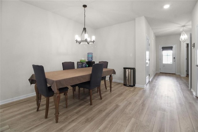dining area featuring a chandelier, light wood-style flooring, baseboards, and recessed lighting