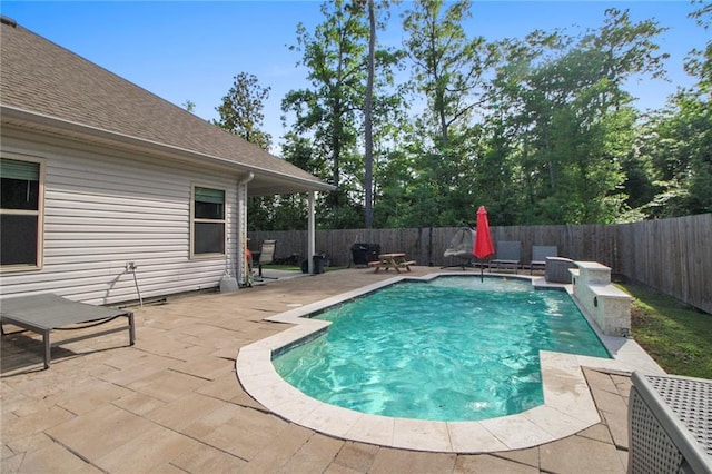 view of swimming pool with a patio and a fenced backyard