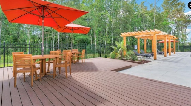 wooden deck with a pergola, fence, and outdoor dining space