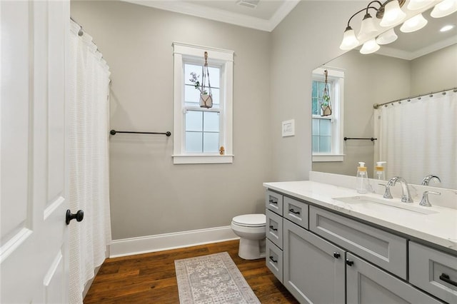 722 Luling Ave, Luling, LA 70070 - full bath featuring wood finished floors, healthy amount of natural light, crown molding, toilet, and vanity