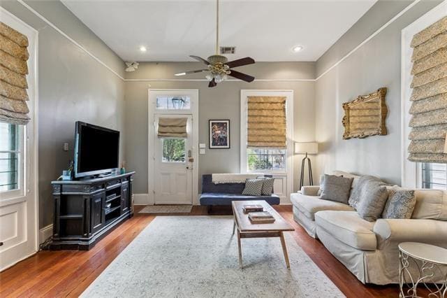 3451 Constance St, New Orleans, LA 70115 - living room featuring healthy amount of natural light, wood finished floors, and ceiling fan