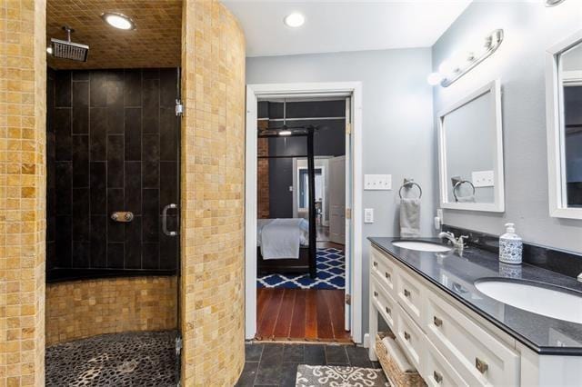 3451 Constance St, New Orleans, LA 70115 - ensuite bathroom with a stall shower, double vanity, recessed lighting, and wood finished floors