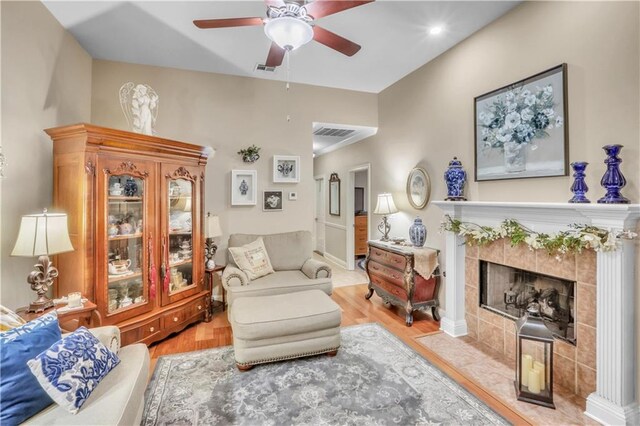 270 Libra Ave Unit B, Mandeville, LA 70471 - living room featuring wood finished floors, a ceiling fan, and a tile fireplace