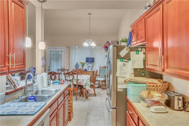 270 Libra Ave Unit B, Mandeville, LA 70471 - kitchen featuring a sink, light tile patterned floors, lofted ceiling, tile countertops, and decorative light fixtures
