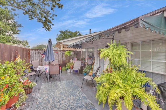 270 Libra Ave Unit B, Mandeville, LA 70471 - view of patio / terrace featuring outdoor dining area, fence, and a wooden deck