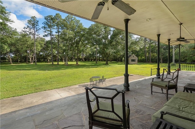 22450 Elderberry Ln, Bush, LA 70431 - view of patio with a ceiling fan, view of scattered trees, and an outbuilding