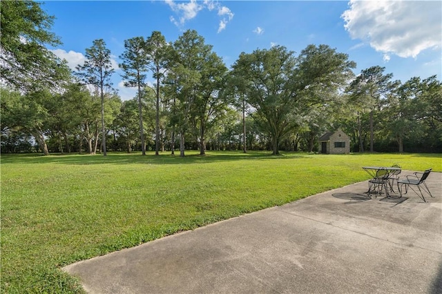 22450 Elderberry Ln, Bush, LA 70431 - view of green lawn featuring a patio and view of wooded area