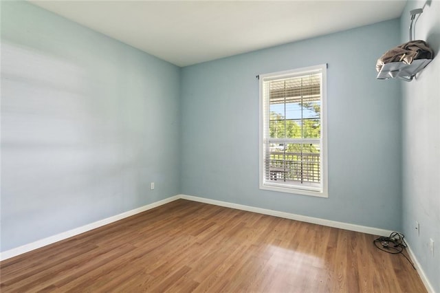 empty room with wood finished floors and baseboards