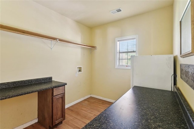 laundry area featuring light wood-style floors, washer hookup, and baseboards