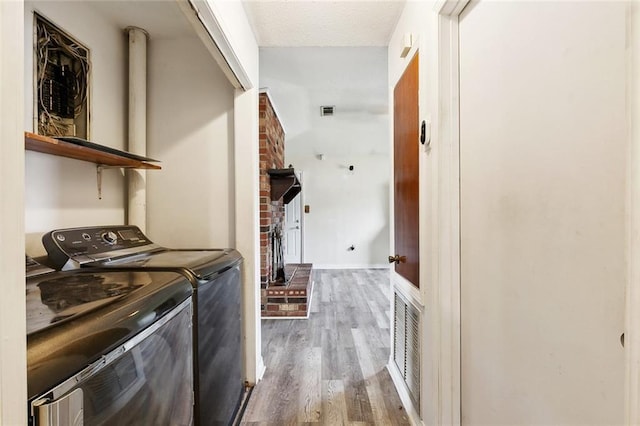 114 Pitre St, Saint Rose, LA 70087 - washroom featuring washing machine and dryer, wood finished floors, and a fireplace