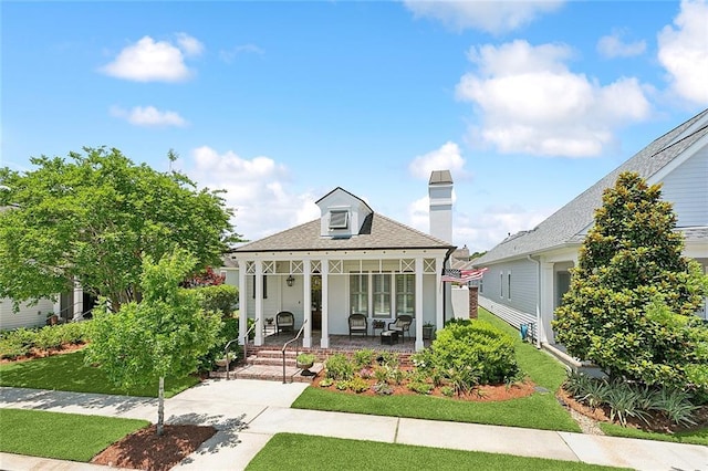 993 Beauregard Pkwy, Covington, LA 70433 - view of front of property with covered porch, a chimney, a front yard, and roof with shingles