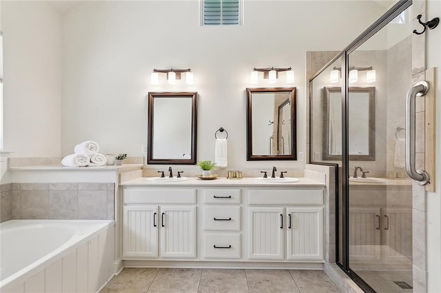 993 Beauregard Pkwy, Covington, LA 70433 - bathroom featuring a bath, double vanity, a shower stall, and tile patterned flooring
