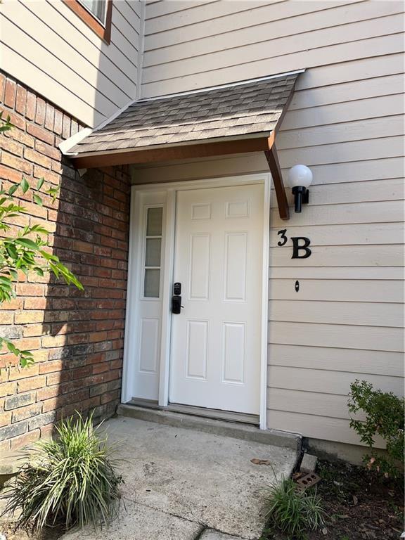1500 W Esplanade Ave Unit 3-B, Kenner, LA 70065 - view of exterior entry with brick siding and roof with shingles
