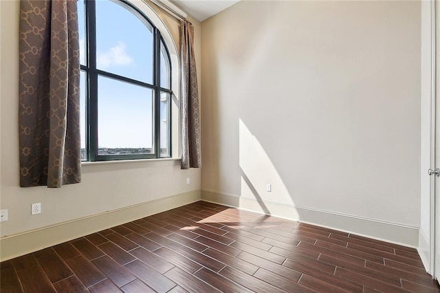 1201 Canal St Unit 521, New Orleans, LA 70112 - unfurnished room featuring healthy amount of natural light, baseboards, and dark wood finished floors