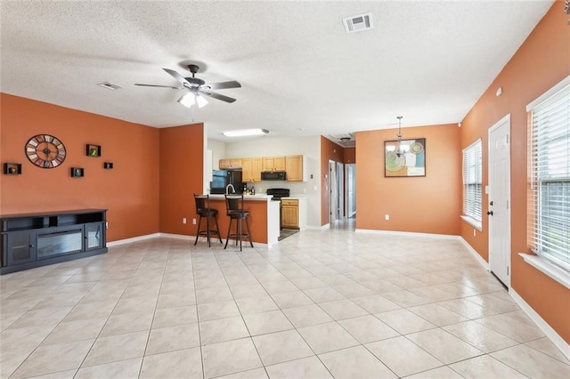 1902 Huey P Long Ave, Gretna, LA 70053 - living area with light tile patterned floors, ceiling fan, baseboards, and a textured ceiling