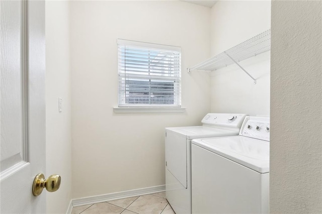 1902 Huey P Long Ave, Gretna, LA 70053 - laundry room featuring separate washer and dryer, light tile patterned floors, and baseboards
