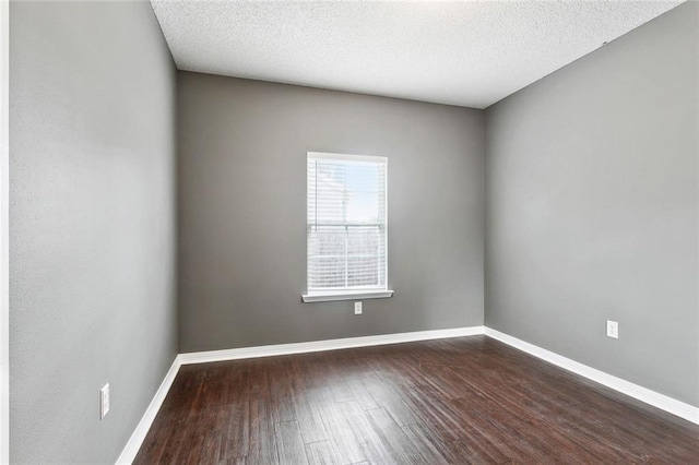 1902 Huey P Long Ave, Gretna, LA 70053 - spare room featuring dark wood finished floors, baseboards, and a textured ceiling