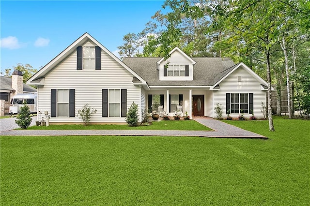 26 Camellia Dr, Covington, LA 70433 - view of front of property with covered porch, a front lawn, and a shingled roof
