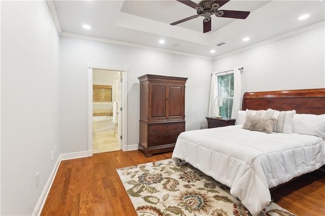 26 Camellia Dr, Covington, LA 70433 - bedroom with wood finished floors, a raised ceiling, baseboards, recessed lighting, and crown molding