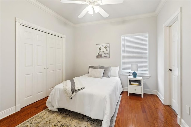 26 Camellia Dr, Covington, LA 70433 - bedroom featuring wood finished floors, crown molding, a closet, a ceiling fan, and baseboards
