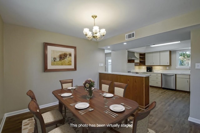 5831 Durbridge Dr, New Orleans, LA 70131 - dining area with a chandelier, wood finished floors, and baseboards