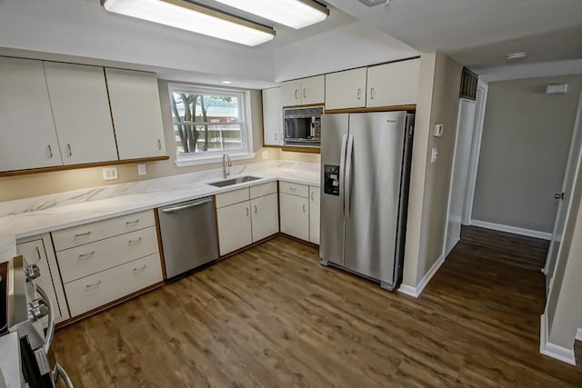 5831 Durbridge Dr, New Orleans, LA 70131 - kitchen with stainless steel appliances, a sink, dark wood-type flooring, white cabinets, and baseboards