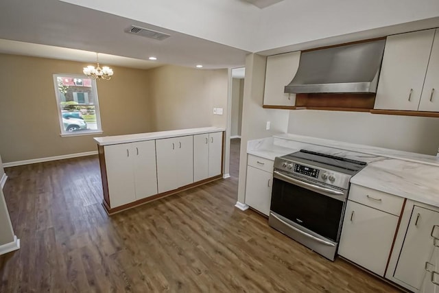 5831 Durbridge Dr, New Orleans, LA 70131 - kitchen featuring stainless steel range with electric stovetop, wall chimney exhaust hood, wood finished floors, baseboards, and a chandelier