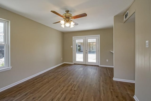5831 Durbridge Dr, New Orleans, LA 70131 - empty room with healthy amount of natural light, dark wood finished floors, a ceiling fan, and french doors